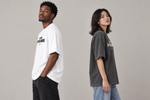 Concept mockup — En Demo Soy Millonario — Tee, side view on two models.