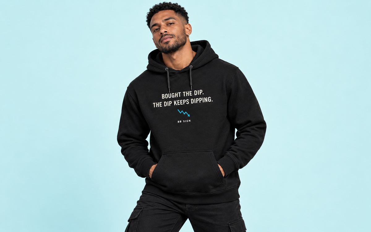 Model wearing the The Dip hoodie against a soft cyan studio backdrop