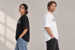 Concept mockup — Se Me Olvidó la Noticia — Tee, side view on two models.