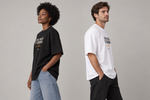 Concept mockup — Una Más y Cierro — Tee, side view on two models.